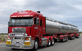 Red semi truck road field - a red semi truck free wallpaper
