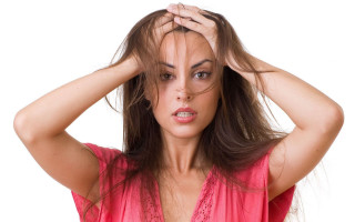 Concerned woman holding hair shock - head and shoulders portrait free wallpaper for desktop