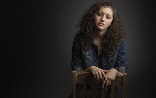 Woman sitting crossed arms serious - a chair free wallpaper