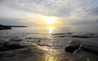 Sunset ocean rocks water island - a small island in the distance free wallpaper for desktop