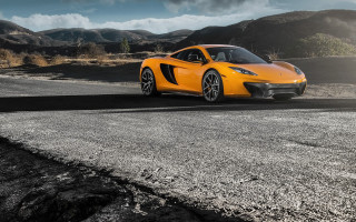 Yellow sports car mountains cloudy - a mountain range in the background free wallpaper