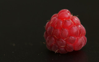 Raspberry black surface bites photorealism - center piece free wallpaper for desktop
