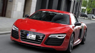 Red car driving tall building - a tall building free wallpaper