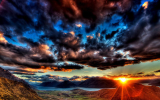 Sunset mountain lake city clouds 3 - orange sun free wallpaper