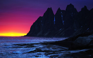 Mountain range sunset ocean waves - against a sunset over the ocean free wallpaper