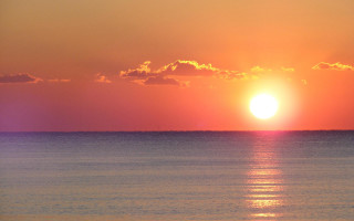 Sunset ocean boat sailboat city - a sunset over the ocean free wallpaper for desktop