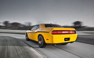 Yellow sports car driving road 4 - a dark sky in the background free wallpaper