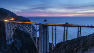 Train bridge ocean mountains dusk - a train free wallpaper