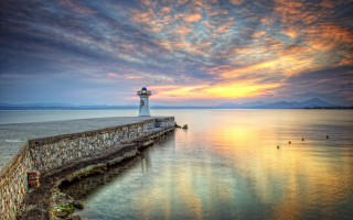 Lighthouse sunset pier clouds water - a pier free wallpaper for desktop