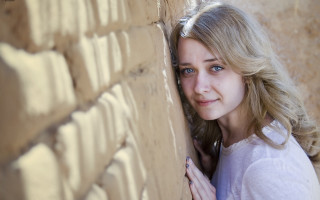 Woman smiling blonde blue nails - a woman leaning against a wall free wallpaper