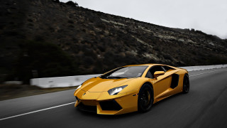 Yellow sports car driving mountain - a road next free wallpaper