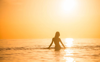 Woman surfboard ocean sunset backlighting - a surfboard in the ocean free wallpaper