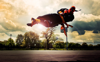 Man skateboard flying park sky - action scene free wallpaper