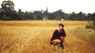 Woman kneeling wheat field red - the background and a sky background free wallpaper