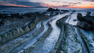 River beach ocean sunset clouds - a rocky beach next free wallpaper