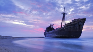 Ship sunset beach water mountain - a pink sky in the background free wallpaper