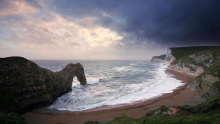Beach rock formation stormy sky - a view of a beach free wallpaper for desktop