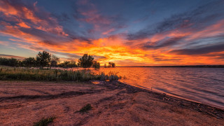 Sunset lake red sky clouds - a grassy area in the foreground free wallpaper