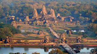 Large building towers lake trees - free city wallpaper