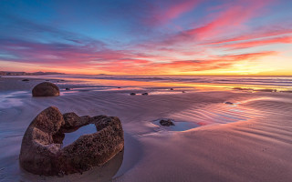 Sunset beach rock formation dusk - a sunset over a beach free wallpaper