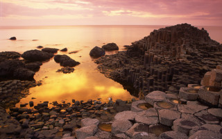 Rocky beach water rock formation 2 - a sunset in the background free wallpaper for desktop