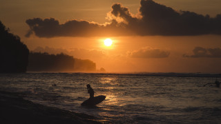 Surfing ocean sunset clouds horizon - a surfboard in the ocean free wallpaper