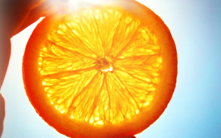 Orange slice photorealism fire explosion - a person holding free wallpaper for desktop