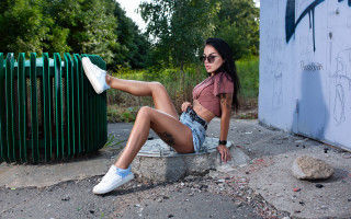 Woman sitting rock white sneakers - a pink shirt free wallpaper