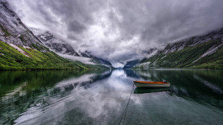 Mountain lake boat cloudy sky - a mountain lake free wallpaper