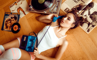 Woman lying floor record player - free vintage wallpaper
