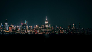 City skyline night plane water - a boat in the foreground free wallpaper for desktop