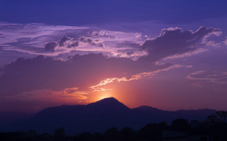 Sunset mountain clouds cityscape beach - a few building free wallpaper