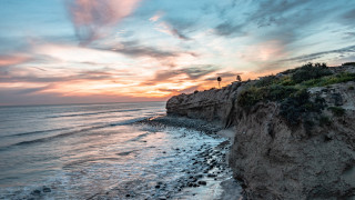 Beach cliff sunset water reflection - a cliff and a body of water free wallpaper