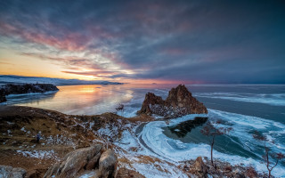 Sunset water mountain beach boat - a mountain in the background and a body of water free wallpaper