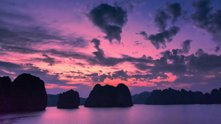 Sunset water rocks clouds mystical - a sunset over a body of water free wallpaper