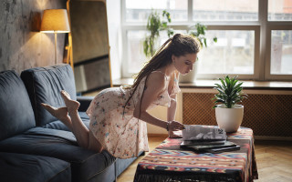 Woman couch magazine plant laptop - a magazine free wallpaper