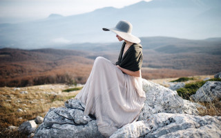 Woman sitting rock hat lake - anka zhuravleva free wallpaper