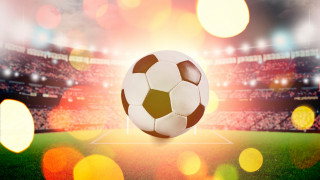 Soccer ball flying over grass - a soccer ball free wallpaper