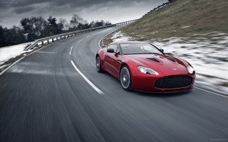 Red sports car driving snow - hillside free wallpaper