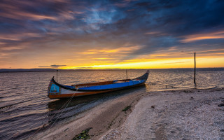 Boat shore lake sunset clouds 2 - a colorful sky in the background free wallpaper