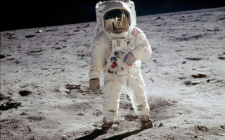 Astronaut walking on moon arm - free space wallpaper