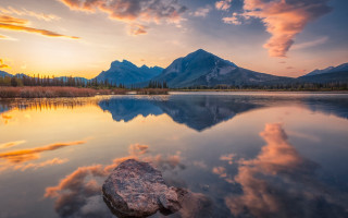 Lake rock mountains sunset clouds - a rock in the middle of it free wallpaper