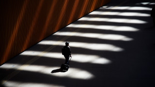 Man walking suitcase shadow backlighting - a sidewalk free wallpaper