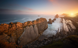 Rocky cliff water sunset mountains - a rocky cliff free wallpaper
