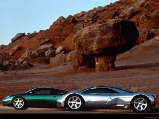 Two cars desert rock formation - a large rock formation in the background free wallpaper