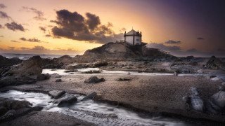 Lighthouse rocky shore sunset cityscape - a rocky shore free wallpaper for desktop