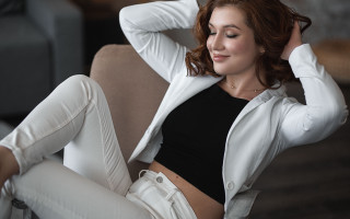 Woman sitting couch hands head - alison geissler free wallpaper