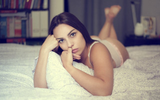 Woman laying bed blurry purple - a white blanket free wallpaper