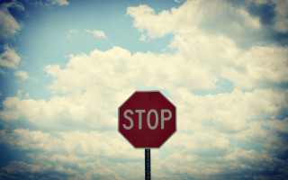 Stop sign sky clouds cityscape - a stop sign free wallpaper for desktop
