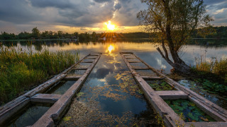 Lake sunset cloudy sky boat - top of a lake under a cloudy sky free wallpaper